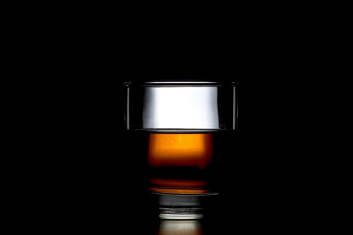 Backlit glass of whisky showing its amber color
