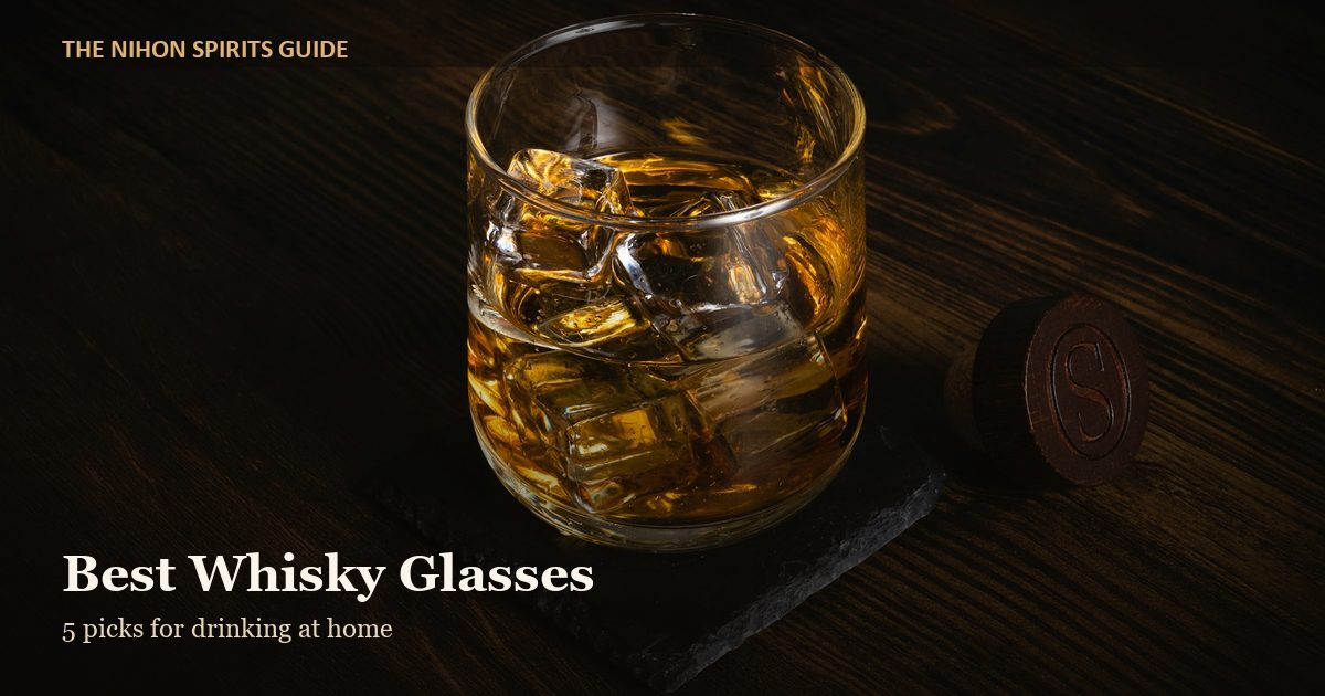 Whisky on the rocks in a glass on a wooden table