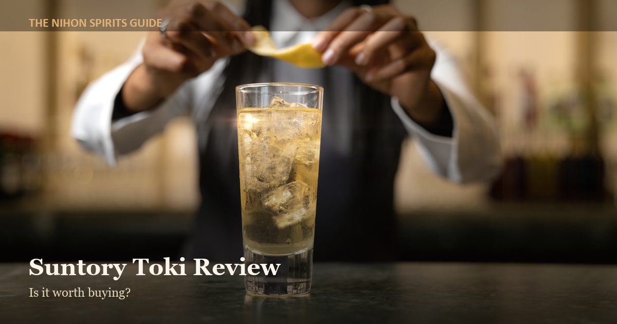 Bartender garnishing a whisky highball with citrus peel